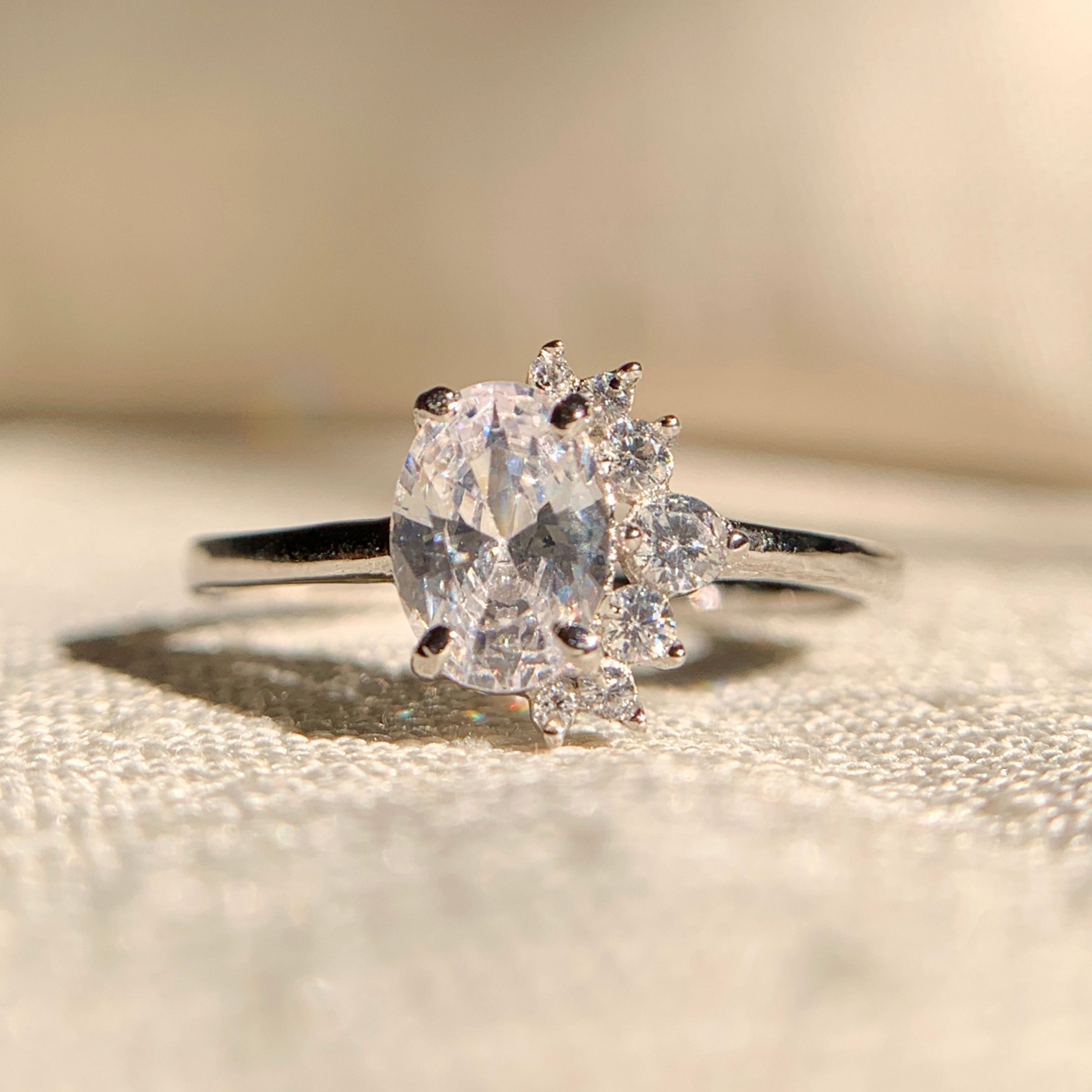 "1 carat oval lab grown diamond cluster engagement ring in white gold"